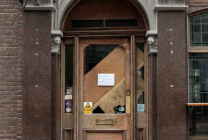 Image of a brown door with a notice attached