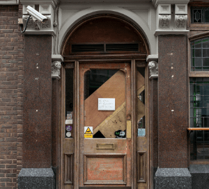 Image of a brown door with a notice attached