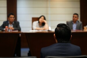 three people in court discussing a case with client